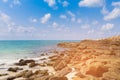 Sand beach and rock over seacoast skyline Royalty Free Stock Photo