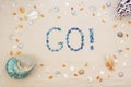 Sand on the beach in summer, the inscription go from the shells on the sand. Flat lay. Top view Royalty Free Stock Photo