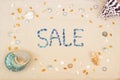 Sand on the beach in summer, the inscription sale from the shells on the sand. Flat lay. Top view Royalty Free Stock Photo