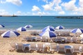 Sand beach with sun umbrellas and lounges Royalty Free Stock Photo