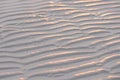 Sand Beach with sunset and Natural wave pattern in sand on a beach texture Royalty Free Stock Photo