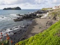 Sand beach of town Vila Franca do Campo with its famous volcanic islet, rock ocean, blue sky and white clouds, Sao Royalty Free Stock Photo