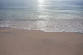 Sand beach with wave and foam water of the sea.