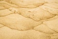 Sand of a beach with wave patterns Royalty Free Stock Photo