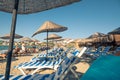 Sand beach in Ãâ¡eÃÅ¸me with straw umbrellas and chaise-longue chairs as very nice background