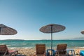 Sand beach in Ãâ¡eÃÅ¸me with straw umbrellas and chaise-longue chairs as very nice background