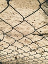 Sand behind the metallic fence at sunny day