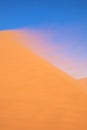 Sand blowing with the wind on Dune 45, Sossusvlei, Namibia. Royalty Free Stock Photo