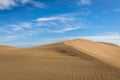 Sand in the Dunes of Maspalomas, a small desert on Gran Canaria, Spain. Sand blowing in the wind on top of the hill. Royalty Free Stock Photo