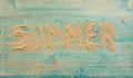 Sand on blue planked wood with the word Summer. Background with copy space. Top view Royalty Free Stock Photo