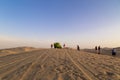 Sand boarding ,Dune Buggy parked in the desert during sunset at Huacachina Oasis in Ica, Peru