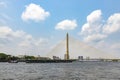 Sand boats are sailing along the Chao Phraya River. Bangkok\'s main river going through the Rama VIII Bridge in the daytime