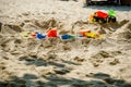 Sand buckets and spade at the beach. children\'s toys for playing on the sand. Bucket and molds for the sandbo Royalty Free Stock Photo