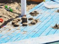 Sand cakes on a blue plank sandbox with colorful childrens toys
