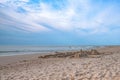 Sand castle on the beach against the background of a pre-sunset summer sky. Summer fun and games Royalty Free Stock Photo