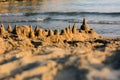 Sand castle, low view, with the sea in the background Royalty Free Stock Photo