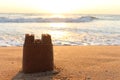 Sand castle on sandy beach in sea shore at sunset time , summer holiday vacation at tropical island Royalty Free Stock Photo