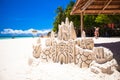 Sand castle on white tropical sandy beach Royalty Free Stock Photo