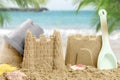 Sand castles with toys on ocean beach, closeup Royalty Free Stock Photo