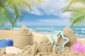 Sand castles with toys on beach. Outdoor play Royalty Free Stock Photo