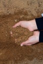 Sand in children`s hands. A child is playing in the sandbox Royalty Free Stock Photo