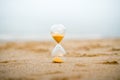 Sand clock on the beach, business time management concept Royalty Free Stock Photo