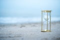 Sand clock on the beach, business time management concept Royalty Free Stock Photo