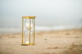 Sand clock on the beach, business time management concept Royalty Free Stock Photo