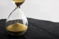 Sand clock , Hourglass as time passing on black slate background , Life time concept Royalty Free Stock Photo