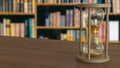 The Sand clock on wood table in library image 3d rendering Royalty Free Stock Photo