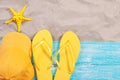 Sand copy space. Sand background top view.Beach towel, beach slippers, yellow bluzer and starfish Royalty Free Stock Photo