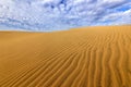 Sand desert with beautiful rare blue sky with white clouds. Summer dry landscape in Africa. Sand waves in the wild nature. Dunas M Royalty Free Stock Photo