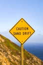 Sand drift sign on the Pacific Ocean coast, California Royalty Free Stock Photo