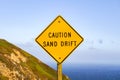Sand drift sign on the Pacific Ocean Coast, California Royalty Free Stock Photo