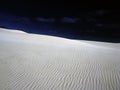 Sand dune against dark sky