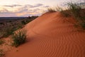 A sand dune with animal tracks and a sunset. Royalty Free Stock Photo