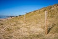 Sand dune and fence on a beach, Re Island, France Royalty Free Stock Photo