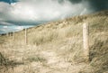 Sand dune and fence on a beach, Re Island, France Royalty Free Stock Photo