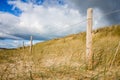 Sand dune and fence on a beach, Re Island, France Royalty Free Stock Photo