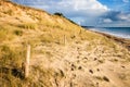 Sand dune and fence on a beach at sunset. Re Island Royalty Free Stock Photo