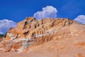 Sand dunes against the blue sky and white clouds Royalty Free Stock Photo