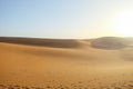 Sand dunes against clear blue sky background in Sahara desert. Royalty Free Stock Photo