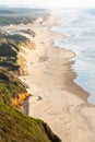 Sand dunes alongside the Pacific Ocean reaching to the distance on the Oregon Coast Royalty Free Stock Photo