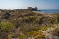 Sand dunes in the background of the medieval castle in Torre Astura in Lazio, Italy