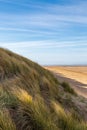 Marram grass covered sand dunes and the vast sandy beach, at Formby on the Merseyside coast Royalty Free Stock Photo