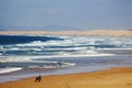 Large sand dunes and wild waves at Australian beach with horse cart