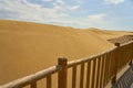 Sand dunes behind a wooden fence. Royalty Free Stock Photo