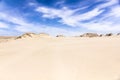 Sand dunes and blue sky with clouds