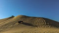Sand dunes and buggies against blue sky at Huacachina, Peru Royalty Free Stock Photo