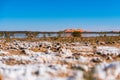 A sand dunes of Erg Chebbi are reflecting in a salt lake. Salt soil on foreground. Landscape shot taken near town Royalty Free Stock Photo